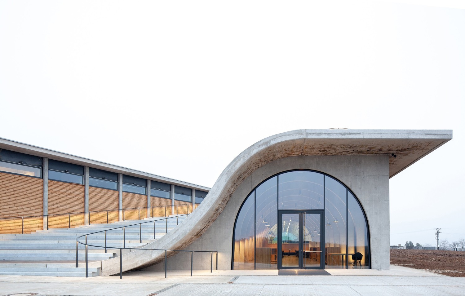 towered by the concave roof of the amphitheater, the space